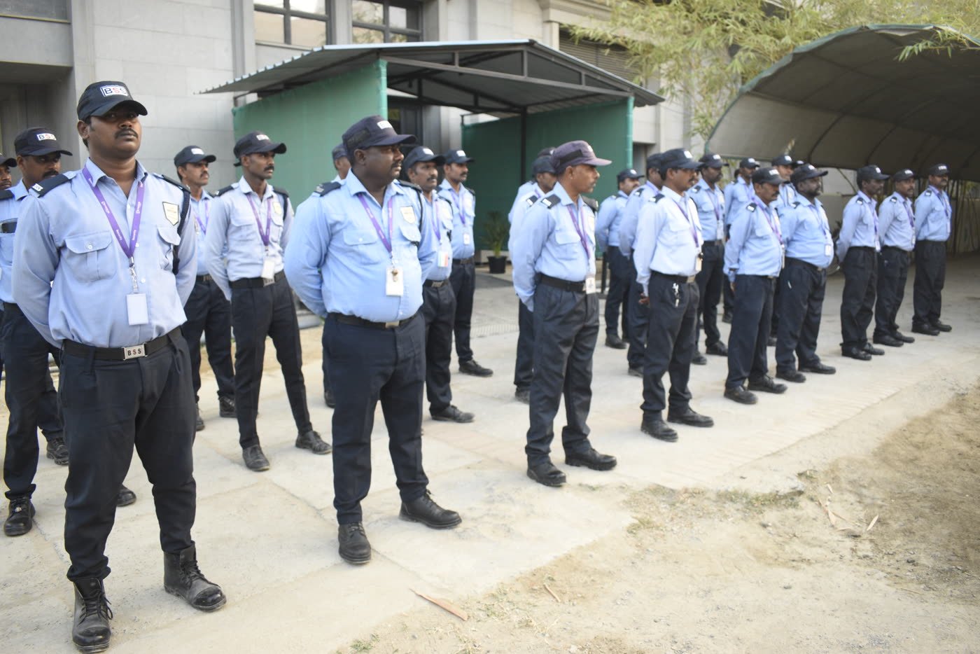 A large BSS team of uniformed guards standing in lines for duty