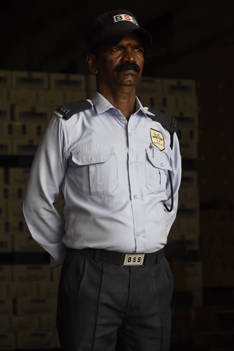 A BSS guard standing at his post inside a warehouse